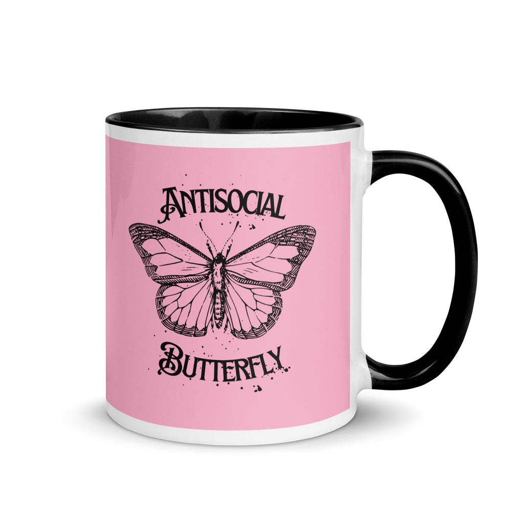 Pink and black ceramic mug with black gothic style text reading “Antisocial Butterfly,” perfect for introverts or gothic coffee lovers.