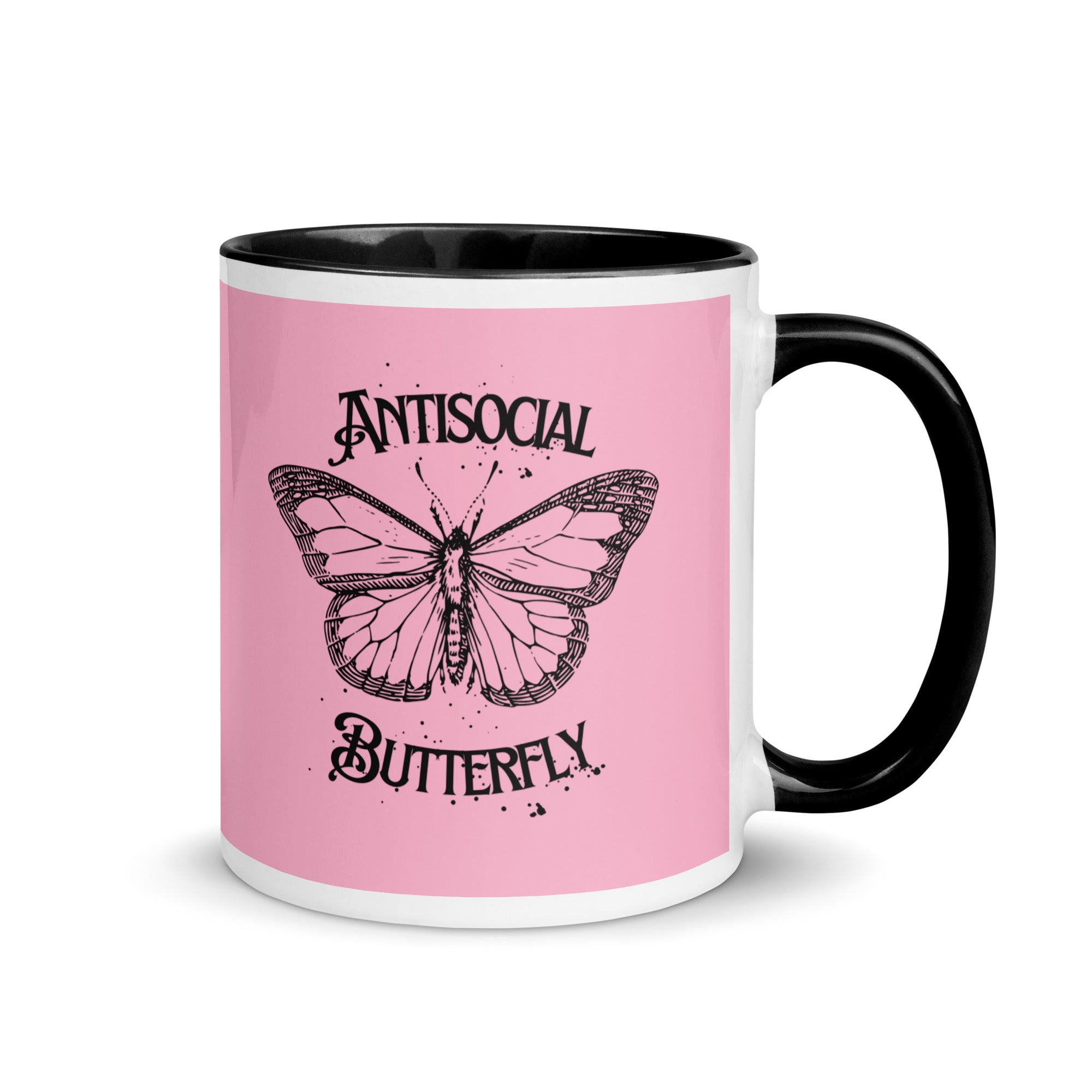 Pink and black ceramic mug with black gothic style text reading “Antisocial Butterfly,” perfect for introverts or gothic coffee lovers.