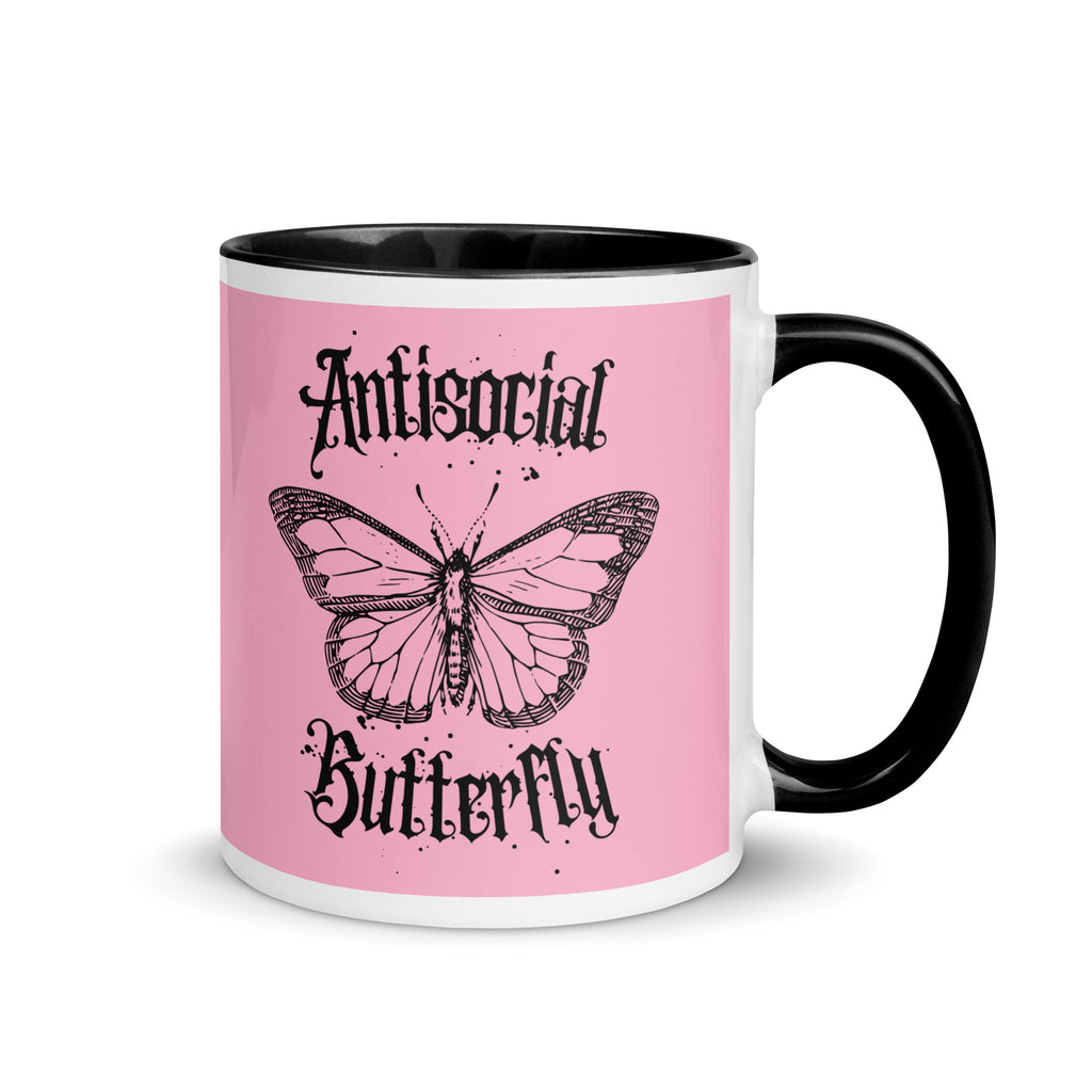 Pink and black ceramic mug with black gothic style text reading “Antisocial Butterfly,” perfect for introverts or gothic coffee lovers.up
