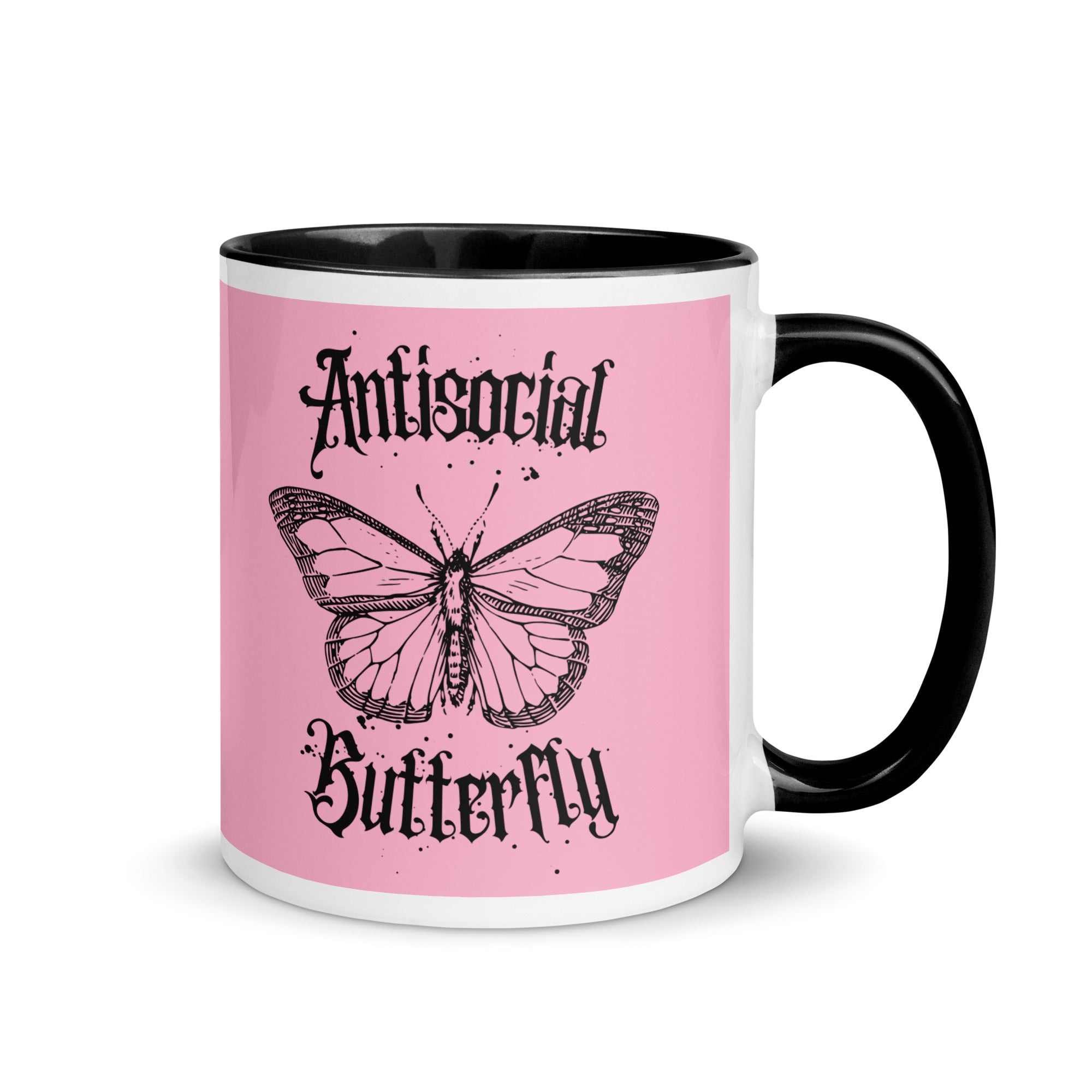 Pink and black ceramic mug with black gothic style text reading “Antisocial Butterfly,” perfect for introverts or gothic coffee lovers.up